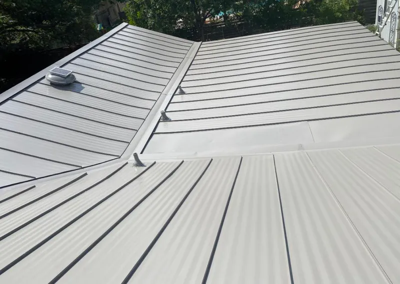 Solar attic fan installed on a metal roof for Roof Ventilation in Butte-Silver Bow